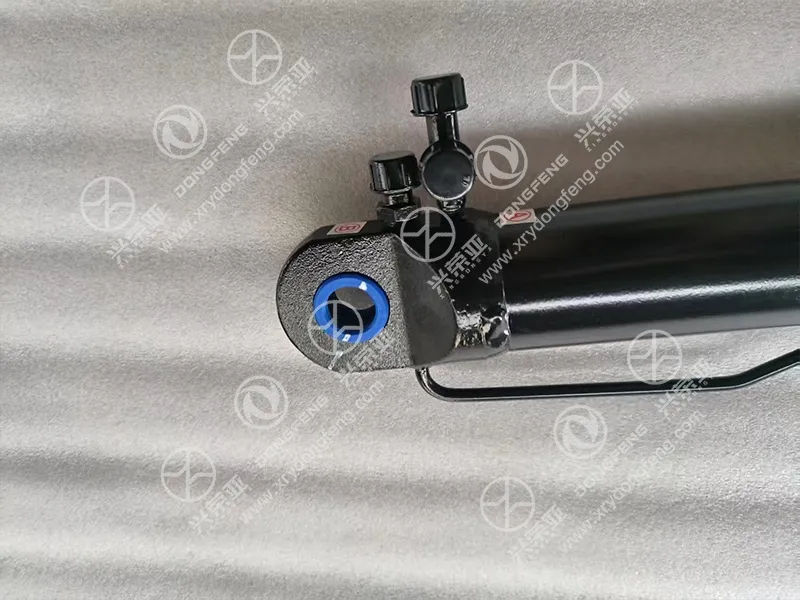 Close-up of top mounting eye and hydraulic oil port cab tilt cylinder OE 5003910-C6102 Dongfeng heavy truck